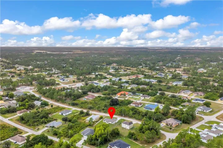 Aerial view of property's location with nearby suburban area