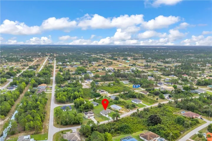 Aerial perspective of suburban area featuring a tree filled landscape