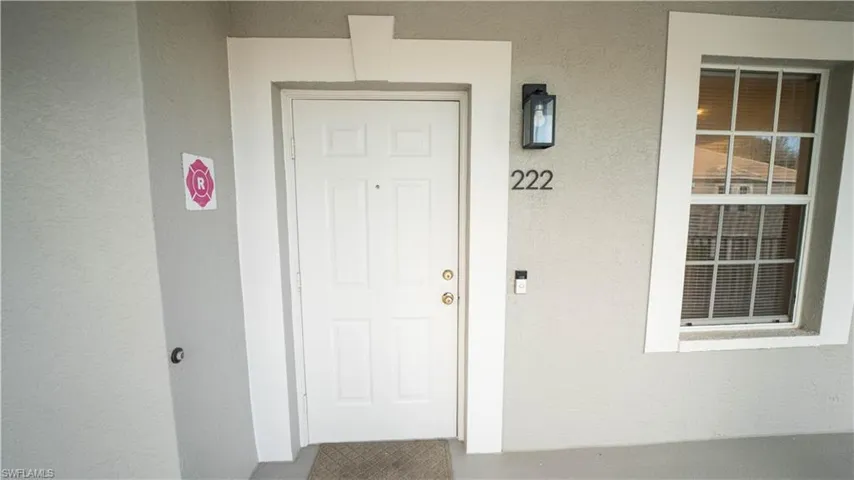 Doorway to property with stucco siding