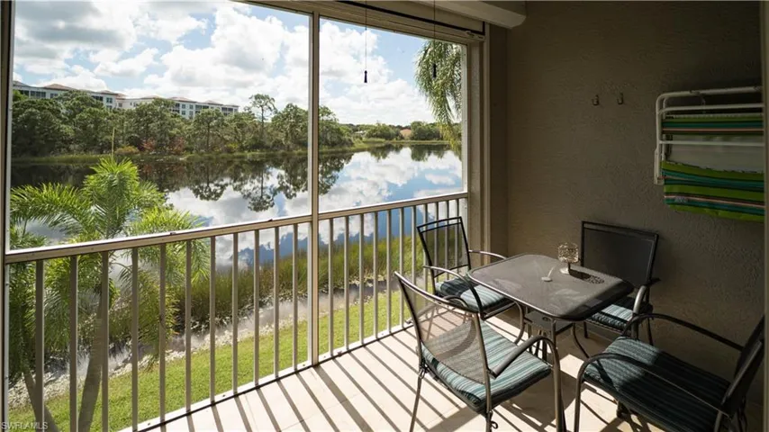 Balcony with a sunroom and a water view