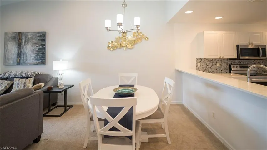 Dining room featuring a chandelier, recessed lighting, and light colored carpet