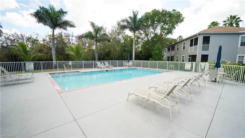 Community pool with a patio