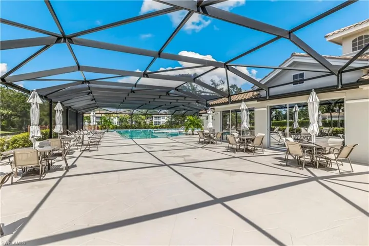 View of pool featuring a patio and glass enclosure