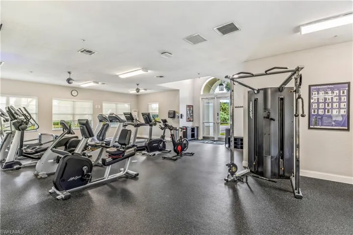 Exercise room with a wealth of natural light and ceiling fan