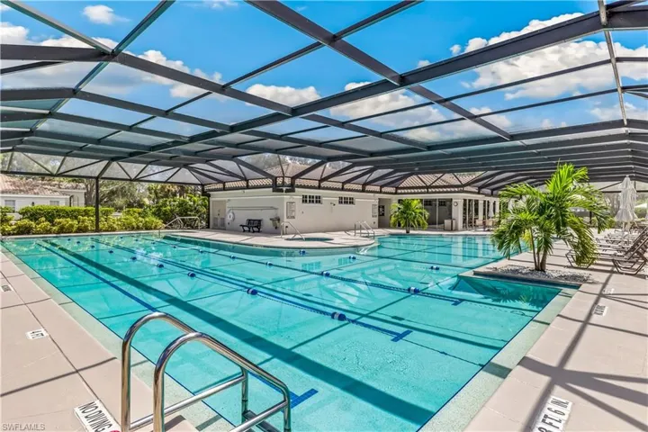 View of swimming pool with a lanai and a patio