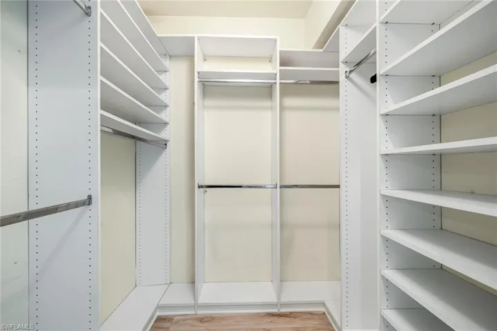 Master bedroom walk in closet with new LTV flooring and built in closet organiazation system