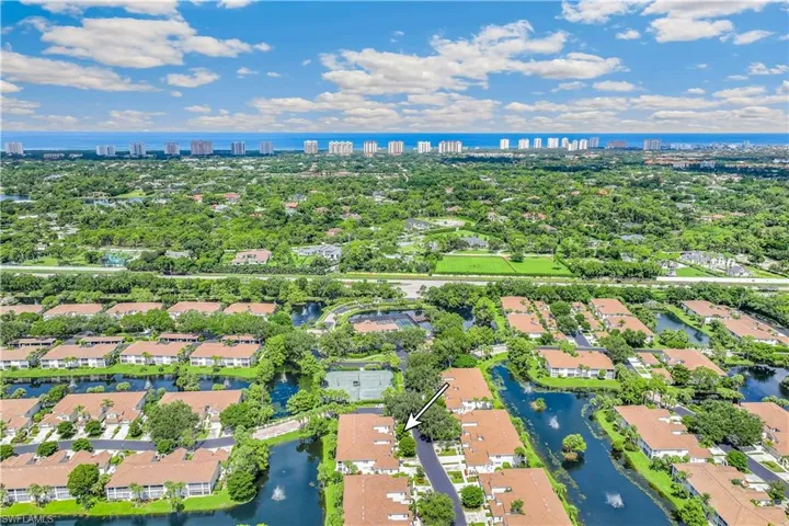 Aerial view of the community and property building featuring a water view