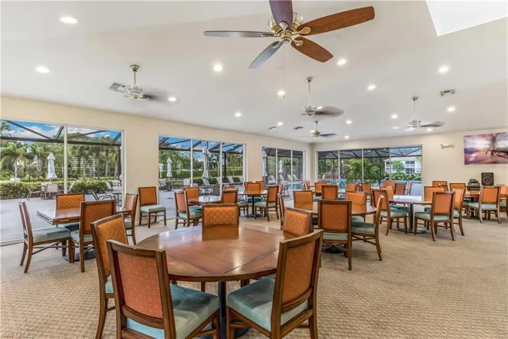 Dining room with light colored carpet and ceiling fan