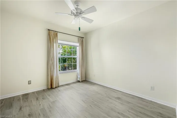 Guest bedroom featuring new LTV flooring and ceiling fan