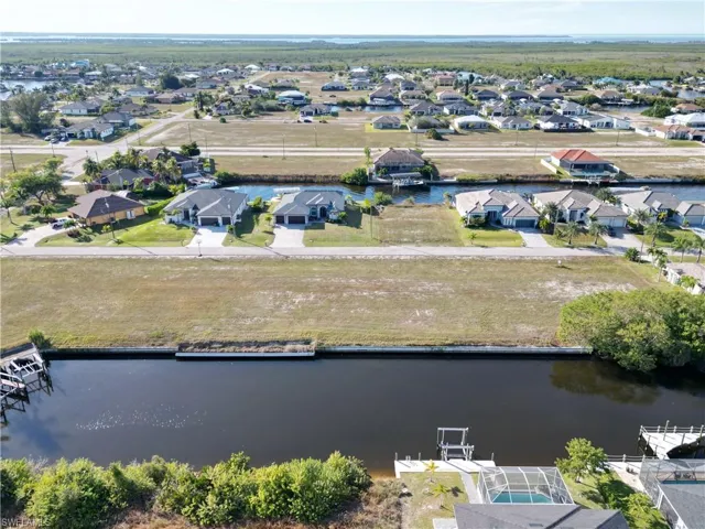 Aerial perspective of suburban area with a large body of water