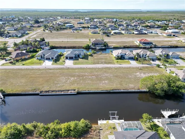 Aerial view of residential area featuring a large body of water