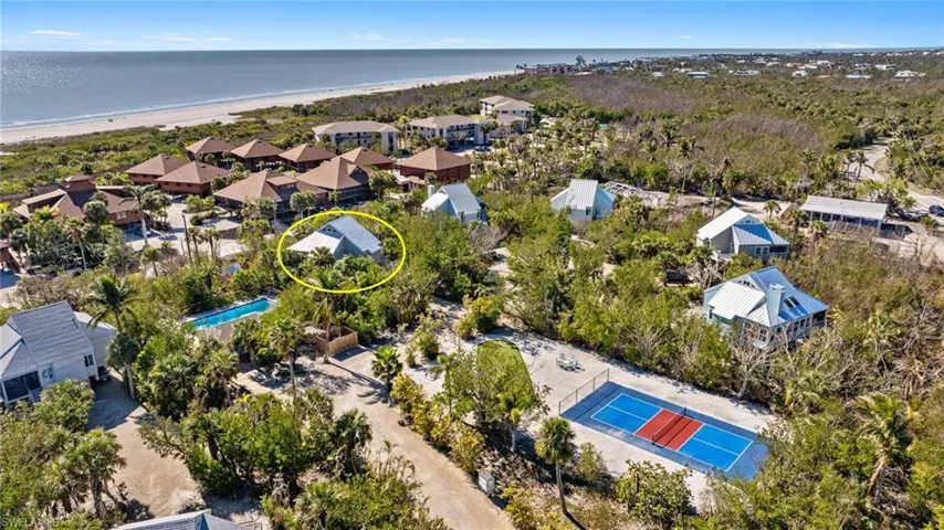 Bird's eye view featuring a water view and a beach view