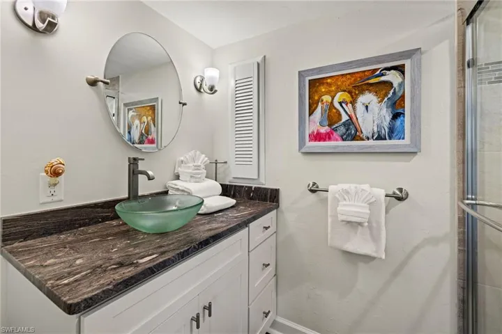 Bathroom featuring vanity and an enclosed shower