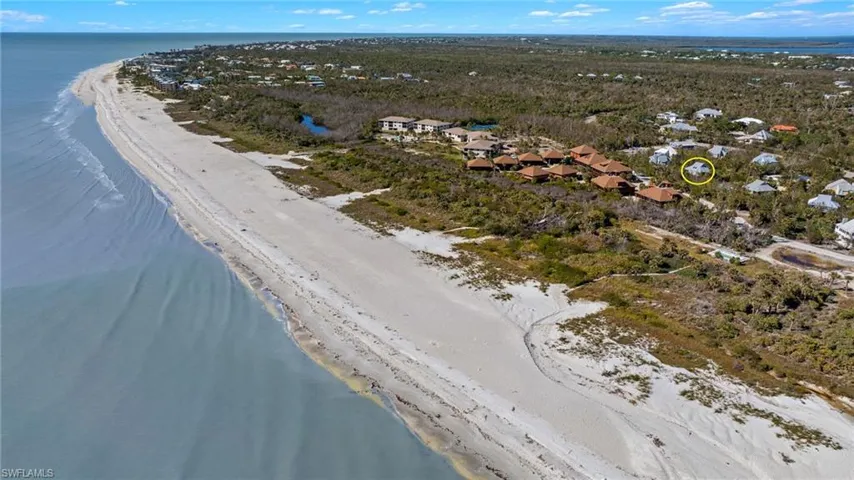 Aerial view featuring a view of the beach and a water view