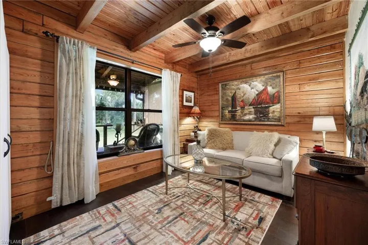 Guest bedroom featuring ceiling fan, beamed ceiling, and wooden ceiling