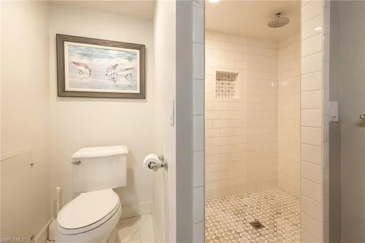 Bathroom featuring toilet and tiled shower