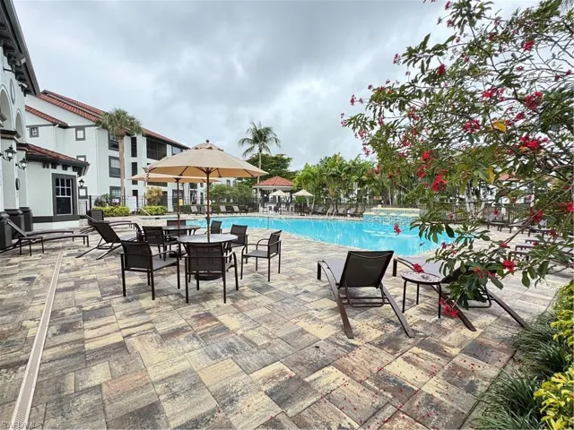 Community pool with a patio area and a jacuzzi