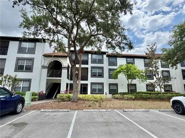 View of property with uncovered parking