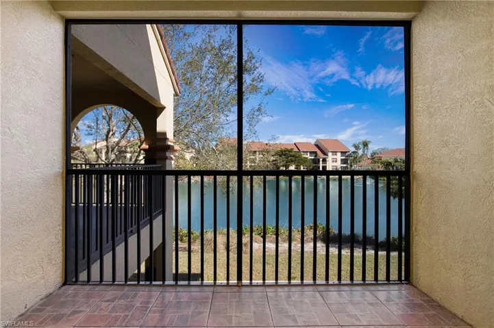 Balcony featuring a water view and a residential view