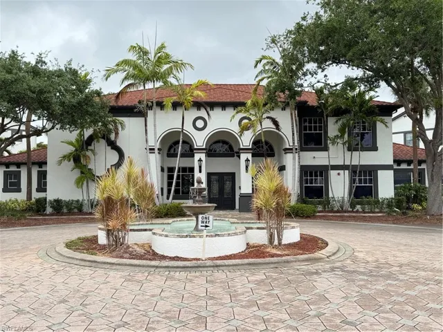 View of property with curved driveway