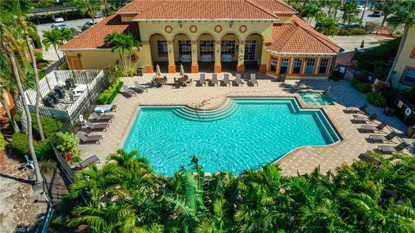 Community pool featuring a fenced backyard and a patio area
