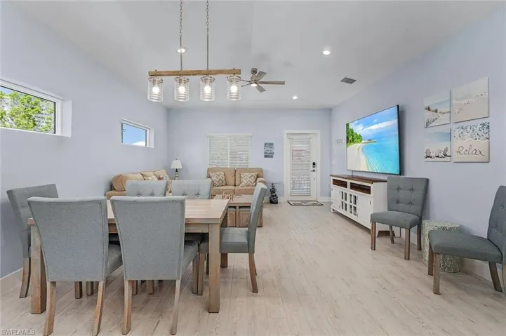 Dining room featuring open feel and view of 85 inch TV