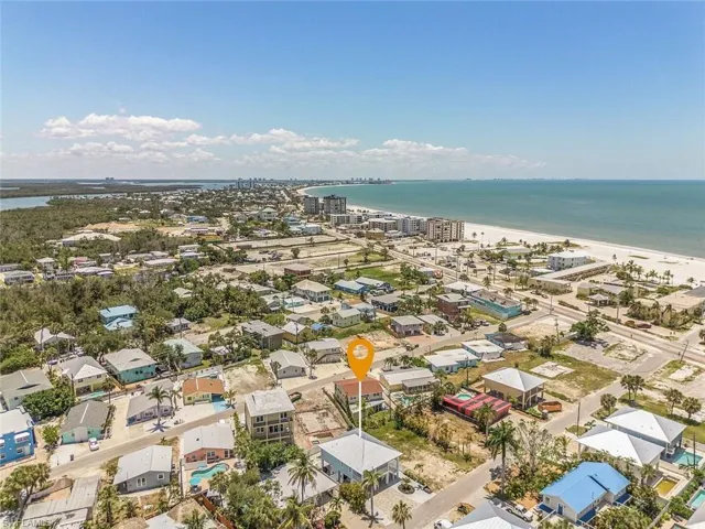 Aerial perspective of suburban area featuring expansive beach