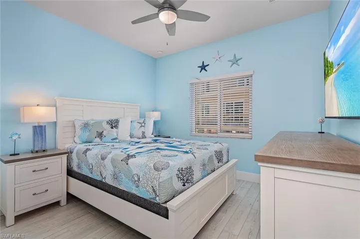 Bedroom with light wood finished floors and a ceiling fan