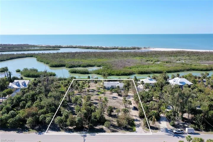 Birds eye view of property with a water view