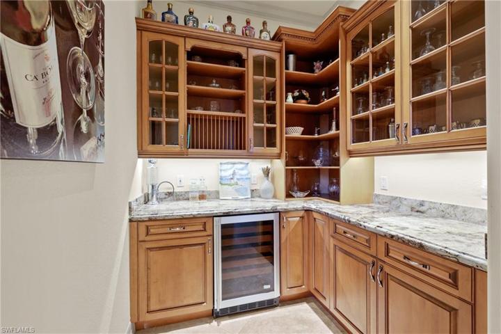 Magnificent wet  bar with under counter wine cooler granite surround.