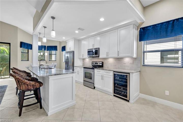 Stainless steel appliances, shaker cabinets, gorgeous granite countertops, wine chiller, this kitchen has it ALL!