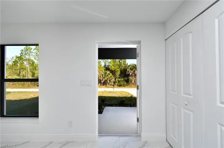 Doorway to outside featuring baseboards