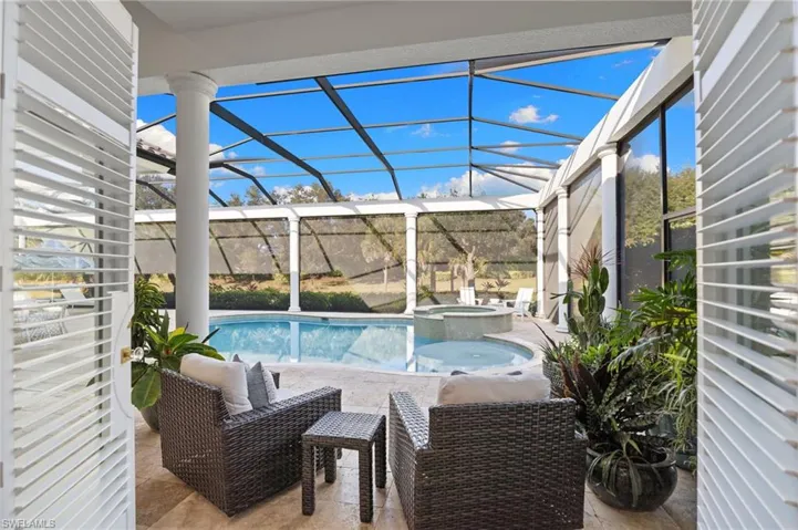 Integrated pool / spa with a patio area, a sunroom, and a lanai