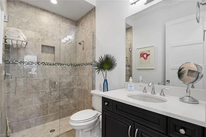 Bathroom featuring vanity and a shower stall