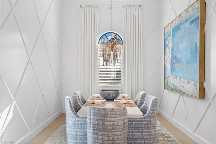 Dining room featuring a decorative wall and wood finished floors