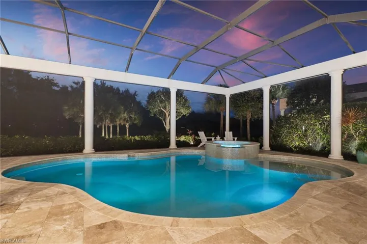 Relaxing pool / spa featuring glass enclosure, a patio, and a sunroom