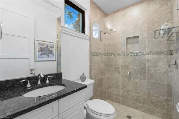 Full bath featuring a shower stall and vanity