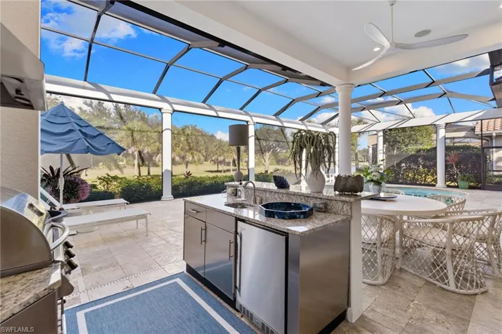 View of patio / terrace featuring area for grilling, a sunroom, and a lanai