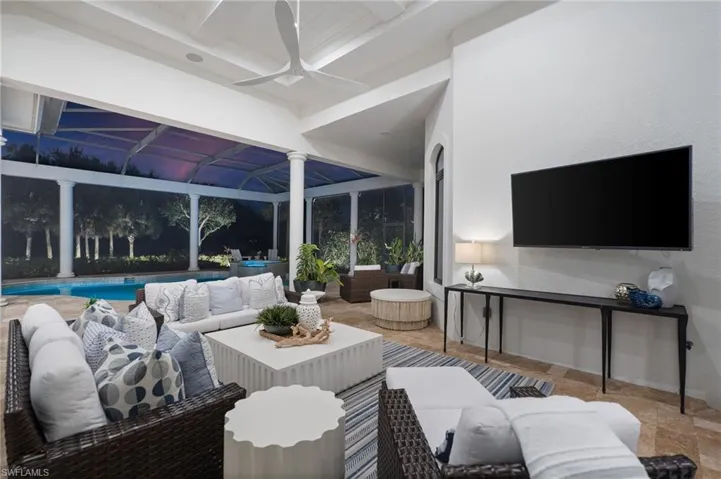 Living area with a sunroom and ceiling fan