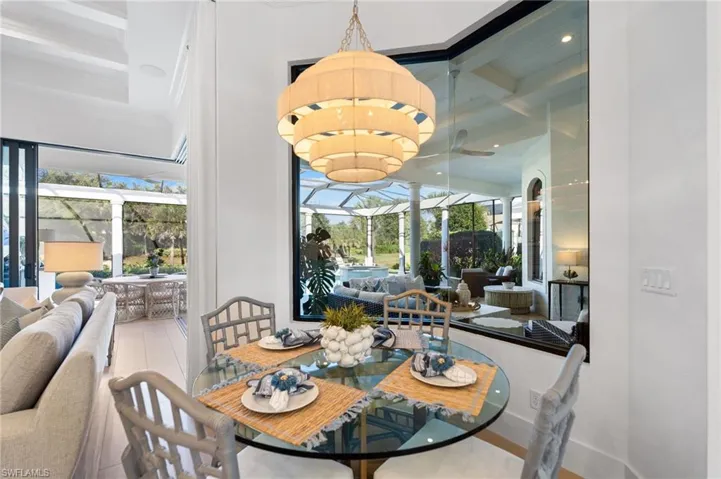 Dining space with a sunroom, coffered ceiling, and recessed lighting