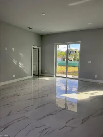 Spare room with marble tiled flooring and recessed lighting