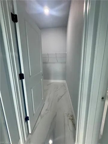 Spacious closet with marble finish floors