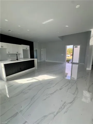 Unfurnished living room with light marble finish flooring