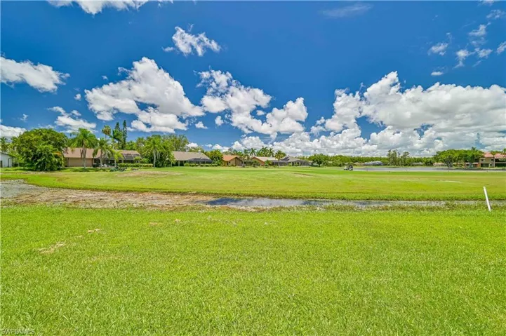 View of green lawn featuring a water view
