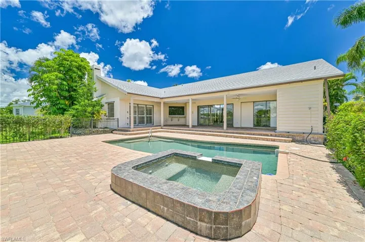 View of swimming pool featuring a patio area and a pool with connected hot tub