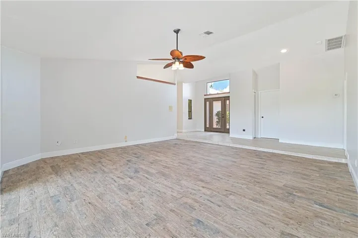 Unfurnished room with light wood-type flooring, vaulted ceiling, recessed lighting, and ceiling fan