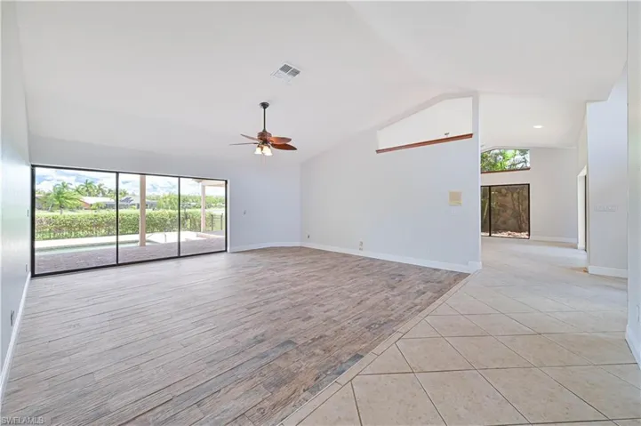 Unfurnished room with light tile patterned floors, high vaulted ceiling, and ceiling fan