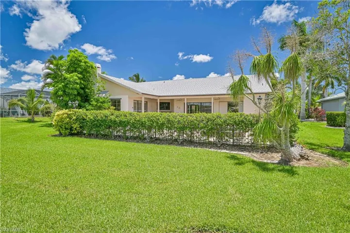 View of front of property with a front lawn and stucco siding
