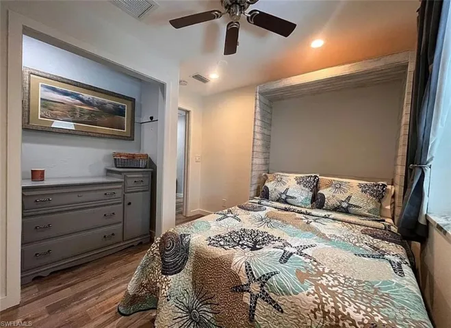 Bedroom with wood finished floors and ceiling fan