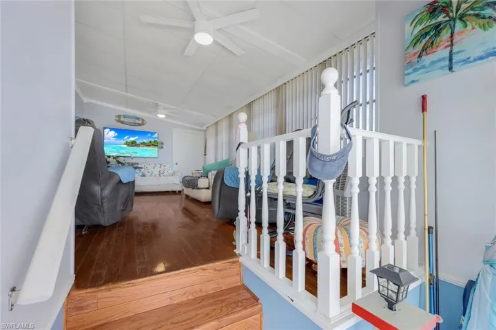 Steps featuring wood-type flooring and ceiling fan